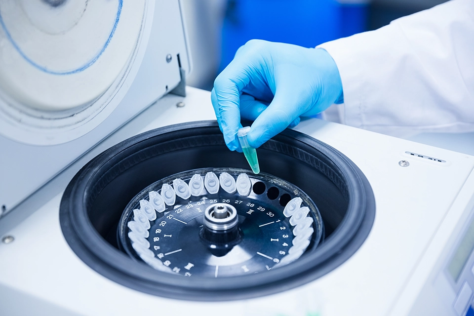 Research team working with laboratory equipment in a biotech facility
